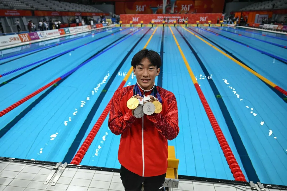 Japan’s Shin Ohashi, who smashed the men’s 200m breaststroke world record on Sept 24, with his medals after the Asian Games swimming events on Sept 25.