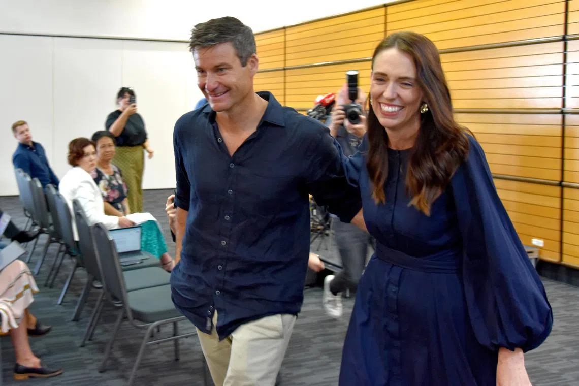 New Zealand Prime Minister Jacinda Ardern (right) leaving with long-time partner Clarke Gayford following the announcement of her resignation.