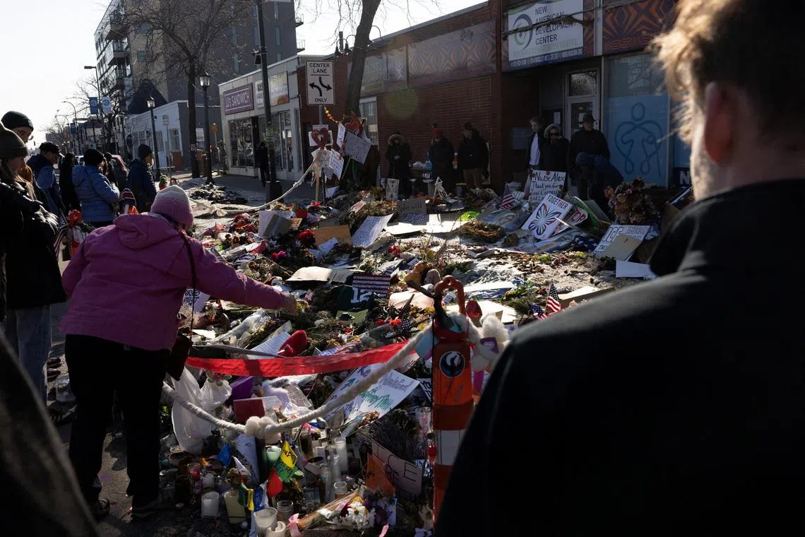 Signs and flowers are placed at the memorial site for Alex Pretti, following the fatal shootings of Pretti and Renee Nicole Good by U.S. federal immigration agents, in Minneapolis, Minnesota, U.S. February 8, 2026.  REUTERS/Go Nakamura