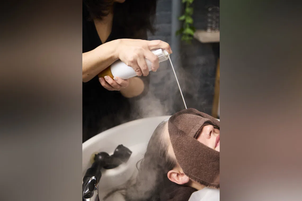 Ms Ritsuko Borges, founder of the Japanese head spa Masa.Kanai, applies a scalp-focused treatment in Manhattan on Oct 9. Ms Borges gives her client a “carbon bath”, which uses concentrated carbonic acid to remove build-up on the scalp.