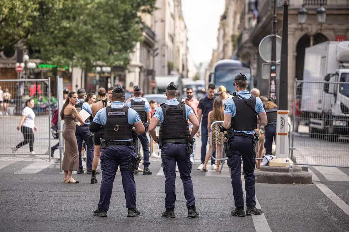 French security forces stand guard as Paris prepares for the opening ceremony of the Olympic Games on July 26, 2024.