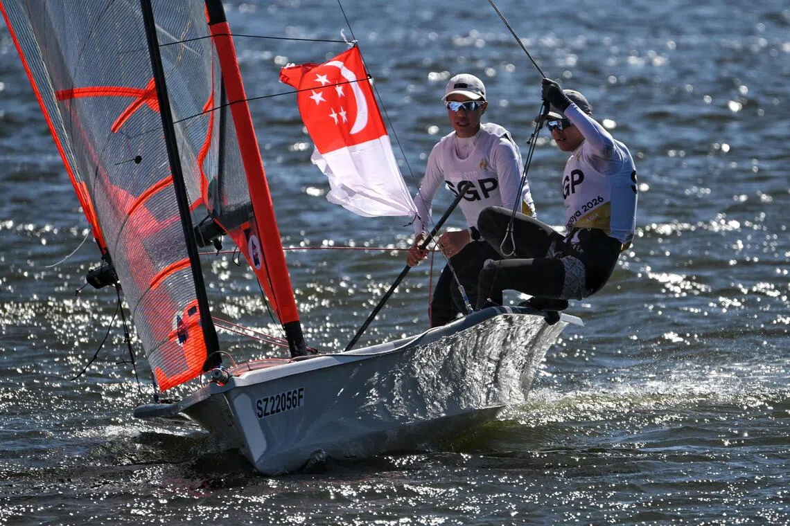 Sean Kum and Nigel Tan with the Singapor flag after the Asian Games Boys? skiff 29er final held at the Kaiyoh Yacht Harbour on Oct 2, 2026.