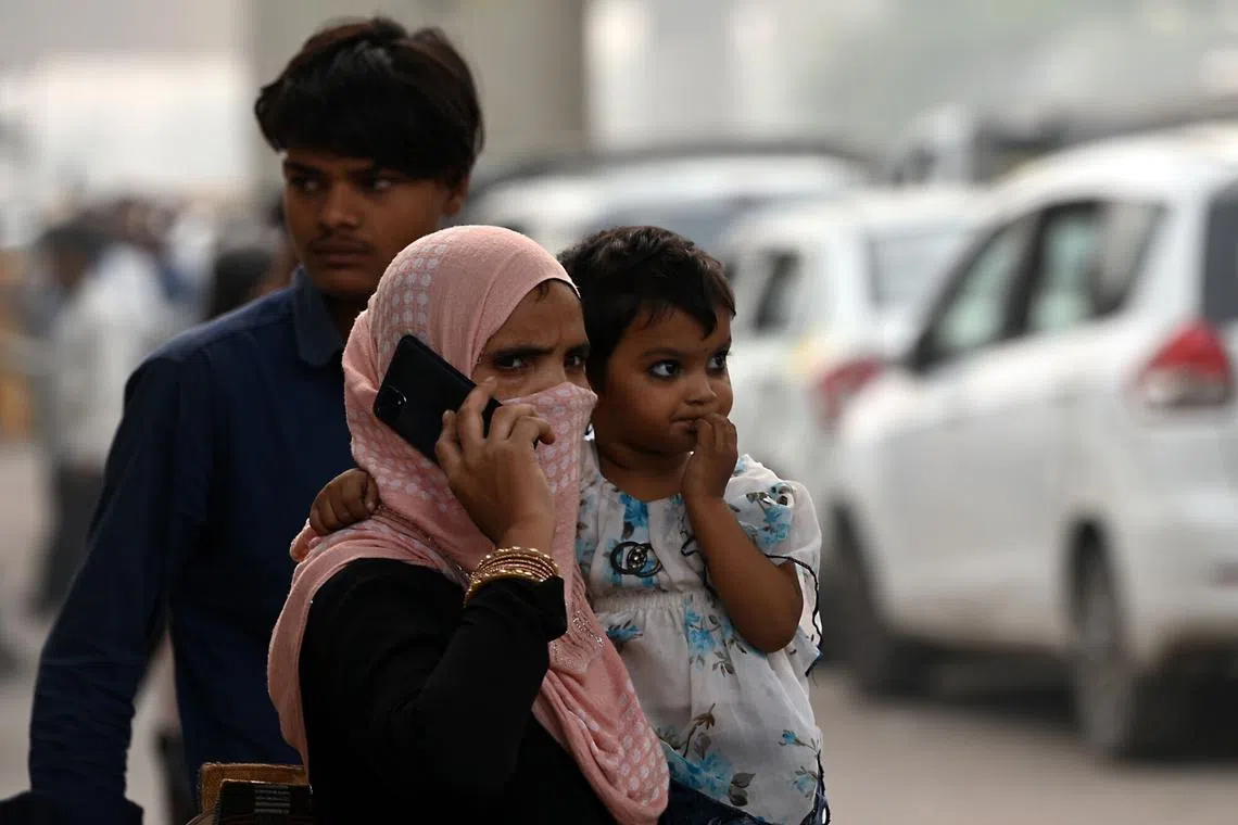 A woman wearing a face mask during her commute amid heavy smog and pollution in New Delhi, India, on Nov 4, 2023. 