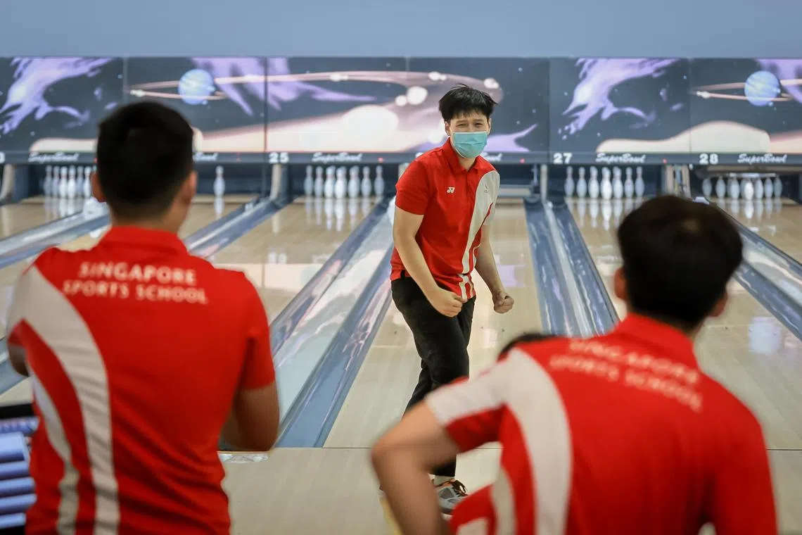 Singapore Sports School’s Brian Ngoi celebrate after scoring a strike at the National School Games Bowling Championship held at SuperBowl Mount Faber, April 6, 2023.
