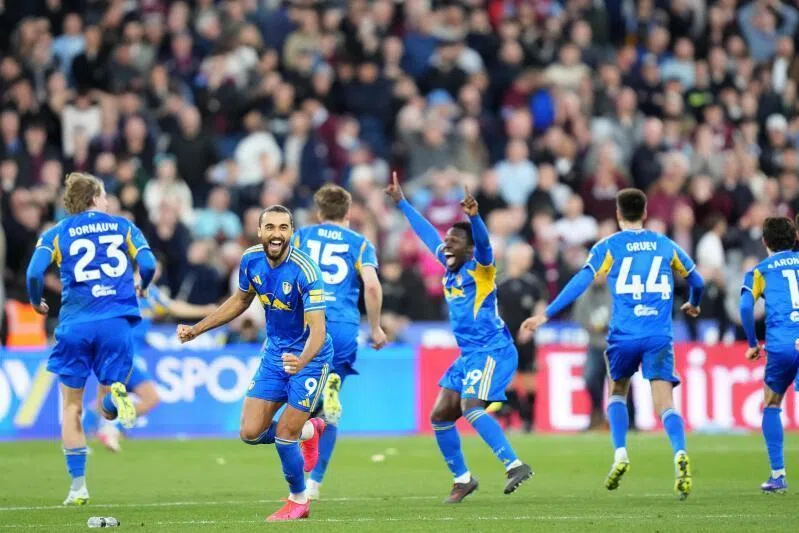 Leeds United's English striker Dominic Calvert-Lewin (second from left) and teammates celebrate after winning the shoot-out.
