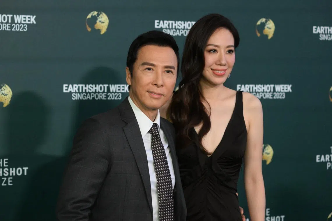 Hong Kong actor Donnie Yen (left) and his wife Cissy Wang posing on the green carpet ahead of the Earthshot Prize Awards ceremony at Mediacorp Campus on Nov 7, 2023.