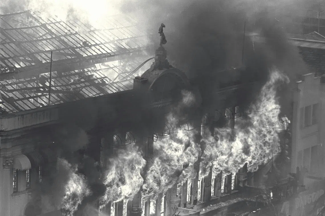 Fire spewing fiercely from the upper windows of Robinson's department store at the height of the blaze at Raffles Place, on November 21, 1972.