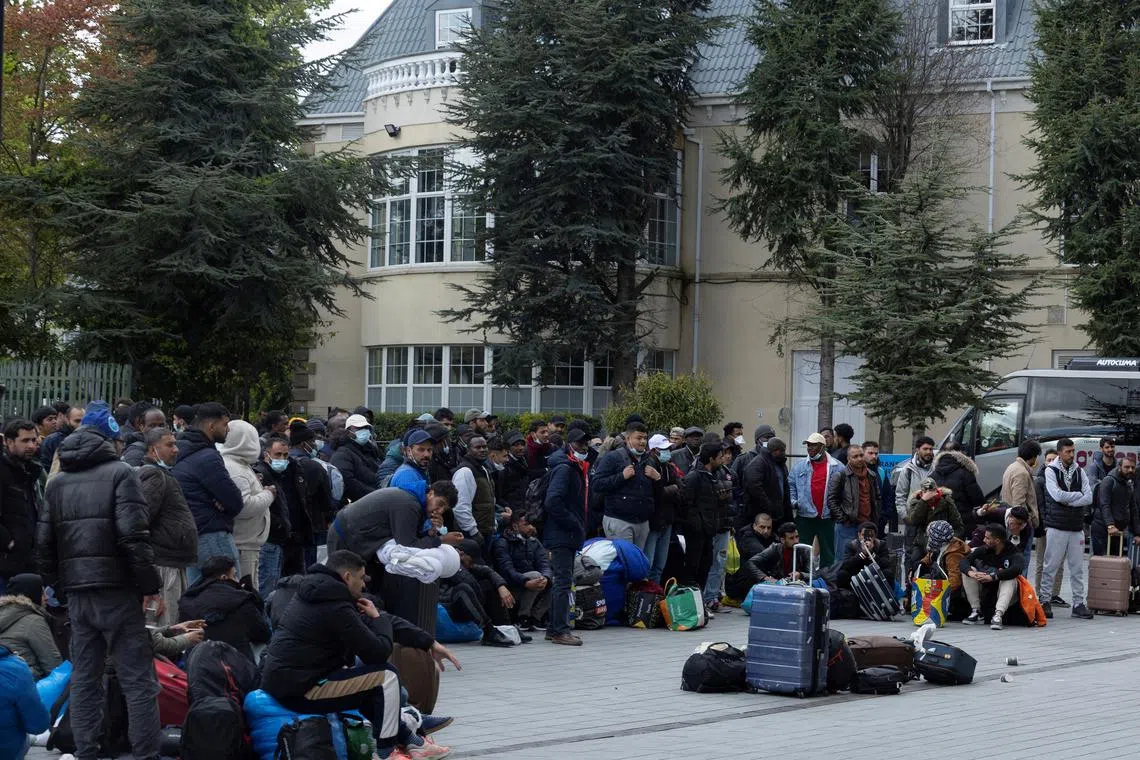 FILE PHOTO: Asylum seekers that were moved from tents camped outside the International Protection Office (IPO) in Dublin City Centre queue to be processed at an International Protection Accommodation Service (IPAS) site providing accommodation, in Citywest, Ireland, May 1, 2024. REUTERS/Clodagh Kilcoyne/File Photo