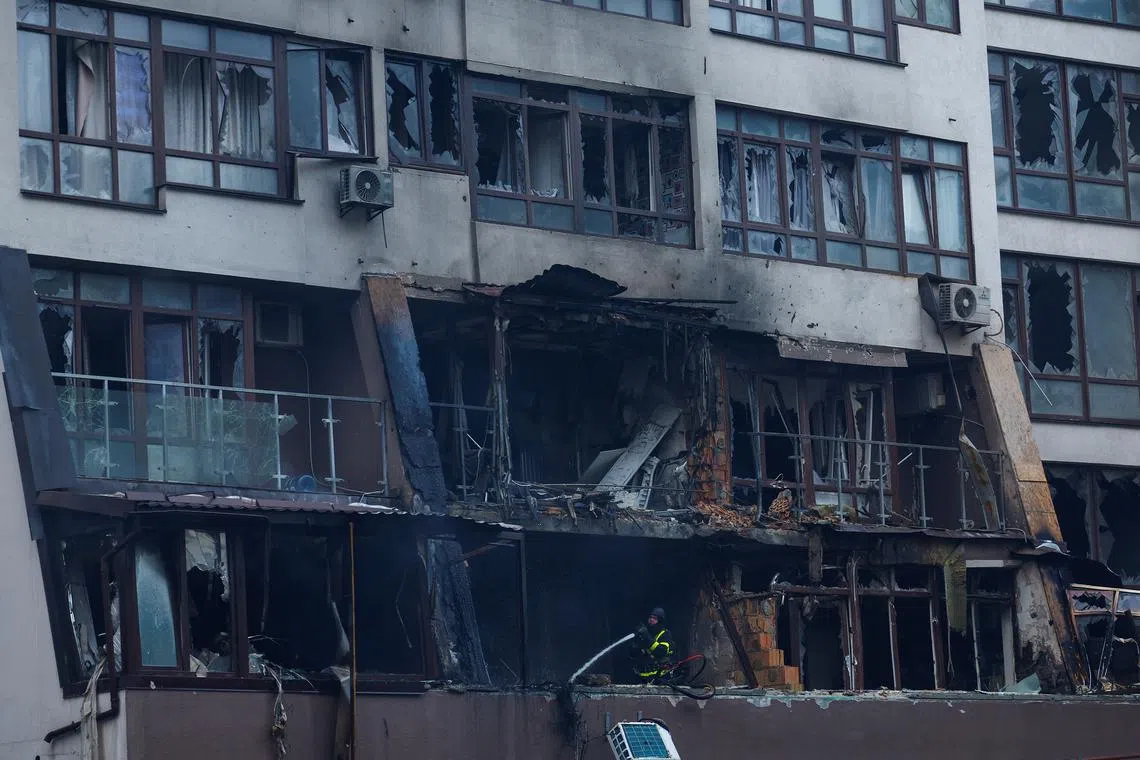 A firefighter works at apartment building hit by a Russian drone strike, amid Russia's attack on Ukraine, in Kyiv, Ukraine July 21, 2025. REUTERS/Valentyn Ogirenko