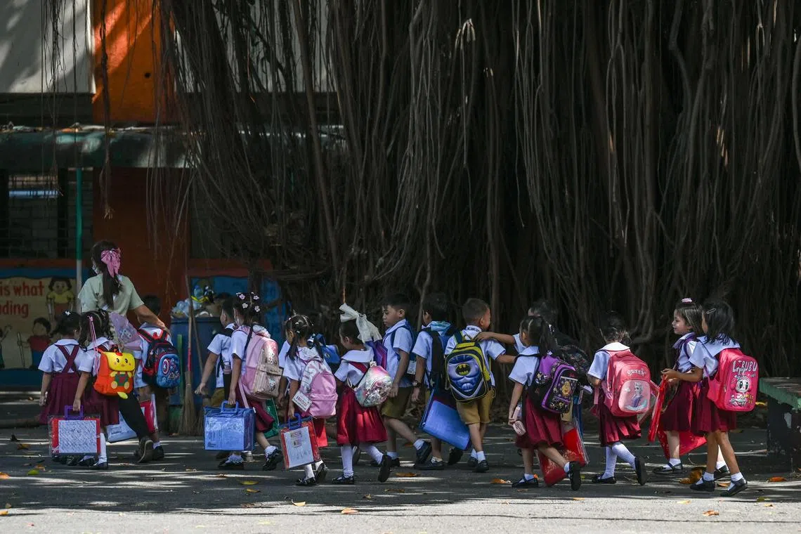 Students leave their school in Manila as school officials suspend classes on March 3 due to extreme heat.