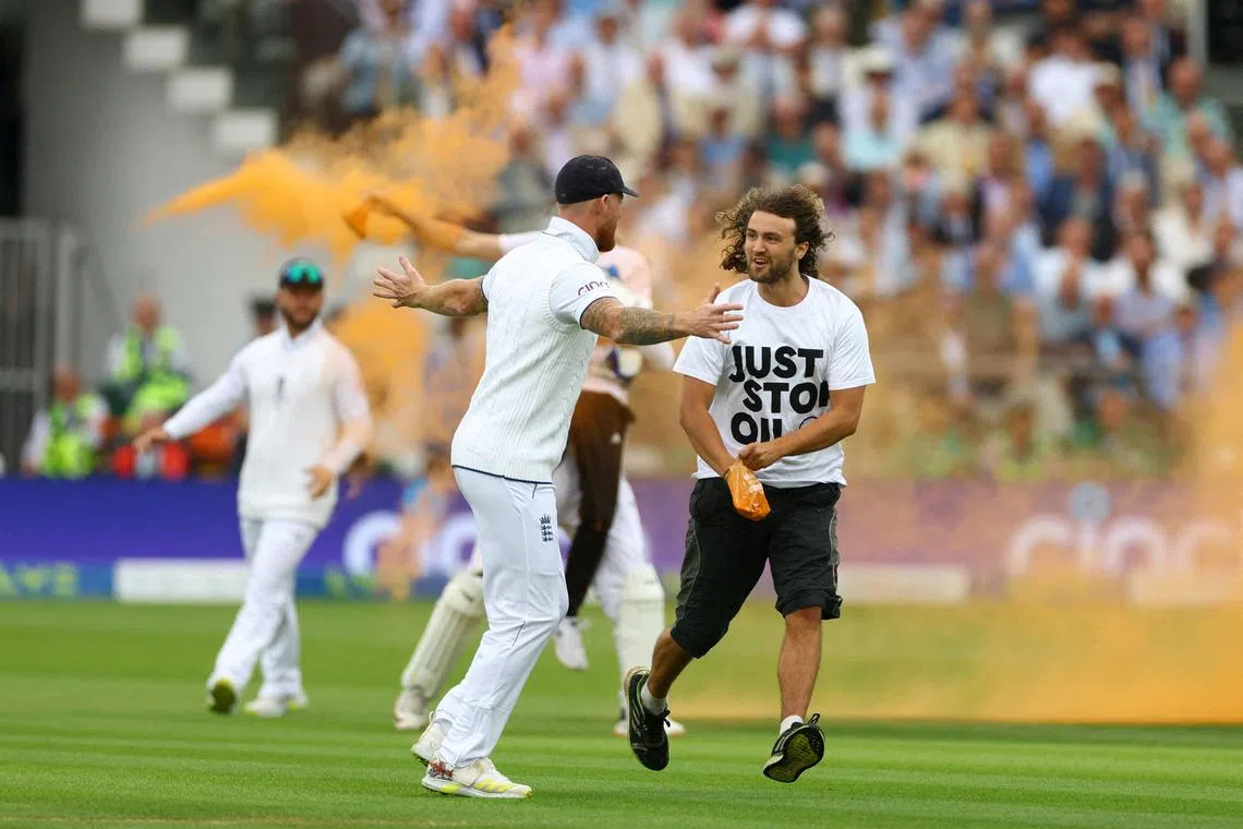England's Ben Stokes trying to stop a "Just Stop Oil" protester during the second Ashes Test at Lord's.