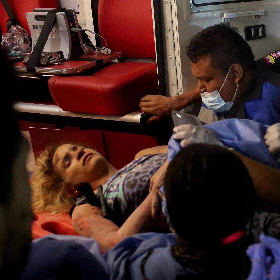Rescuers move Daniela Andrea Largo Sanchez onto an ambulance on Aug 11.