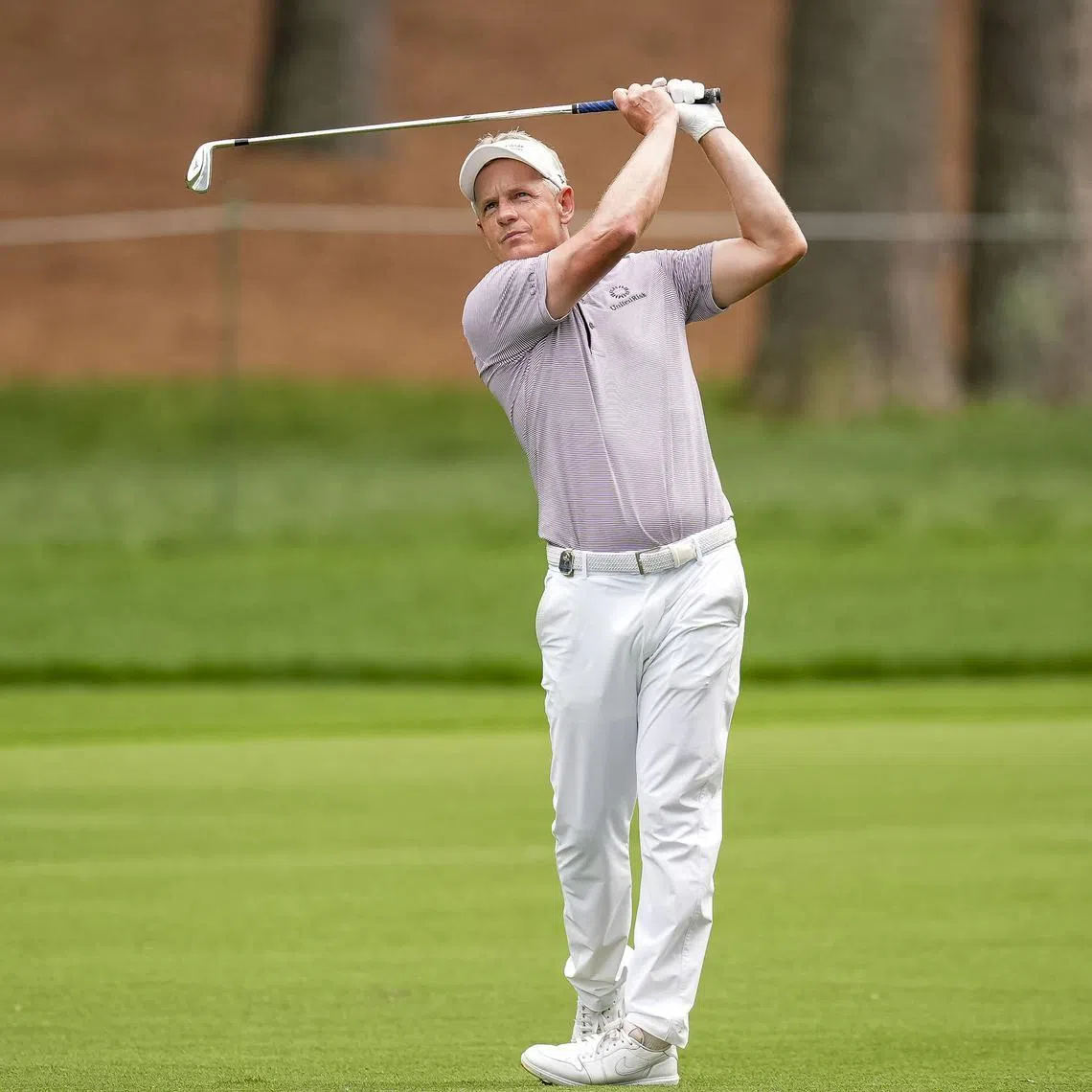 FILE PHOTO: May 16, 2025; Charlotte, North Carolina, USA; Luke Donald hits his second shot on the second hole during the second round of the PGA Championship golf tournament at Quail Hollow. Mandatory Credit: Jim Dedmon-Imagn Images/File Photo