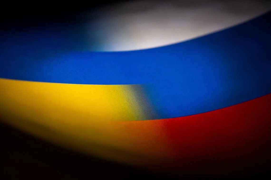 FILE PHOTO: Russia's and Ukraine's flags are seen printed on paper in this illustration taken January 27, 2022. REUTERS/Dado Ruvic/Illustration/File Photo