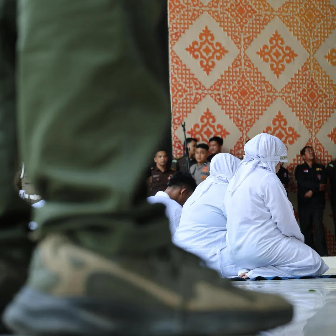 Violators at a public flogging for violating syariah law in Banda Aceh, Indonesia, on July 2.