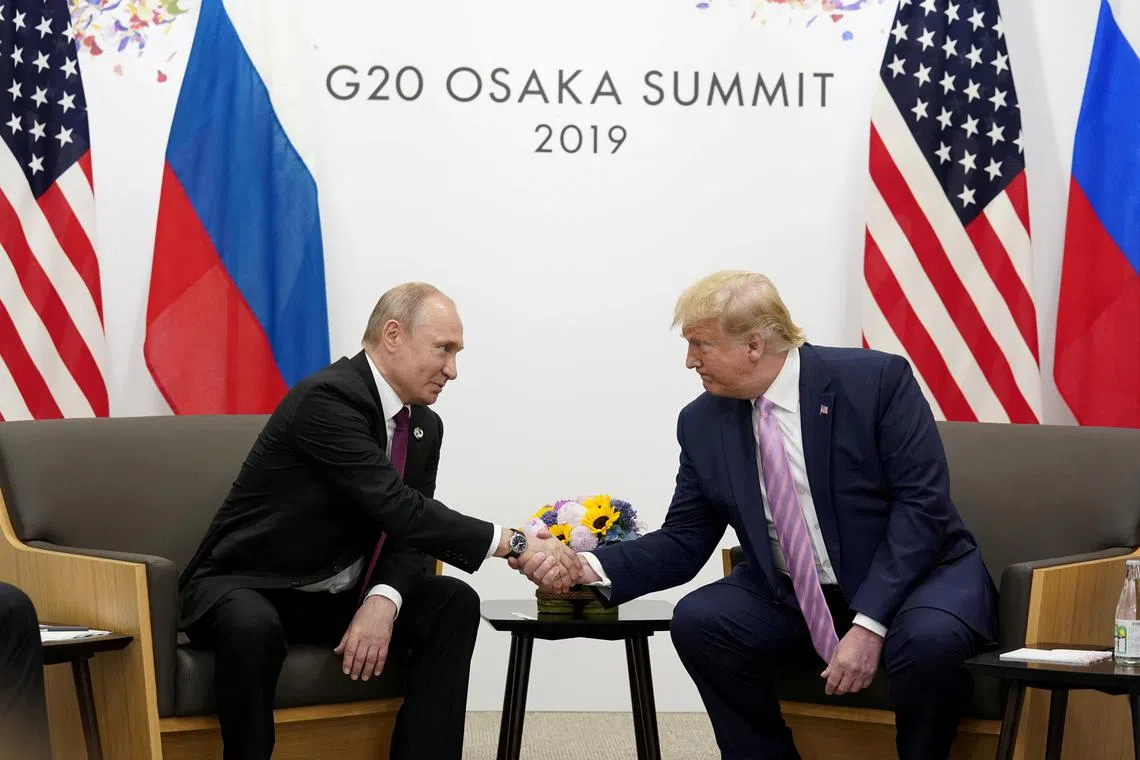 FILE PHOTO: Russia's President Vladimir Putin and U.S. President Donald Trump shake hands during a bilateral meeting at the G20 leaders summit in Osaka, Japan, June 28, 2019.  REUTERS/Kevin Lamarque/File Photo