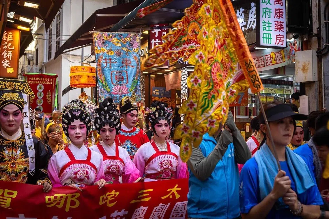 Members of a troupe parading on the streets during the Feast of Na Tcha in Macau, China, on July 1, 2026. The Feast of Na Tcha is a vibrant annual Taoist festival in Macau celebrating the birth of the child-deity Na Tcha. (Photo by Eduardo Leal / AFP)