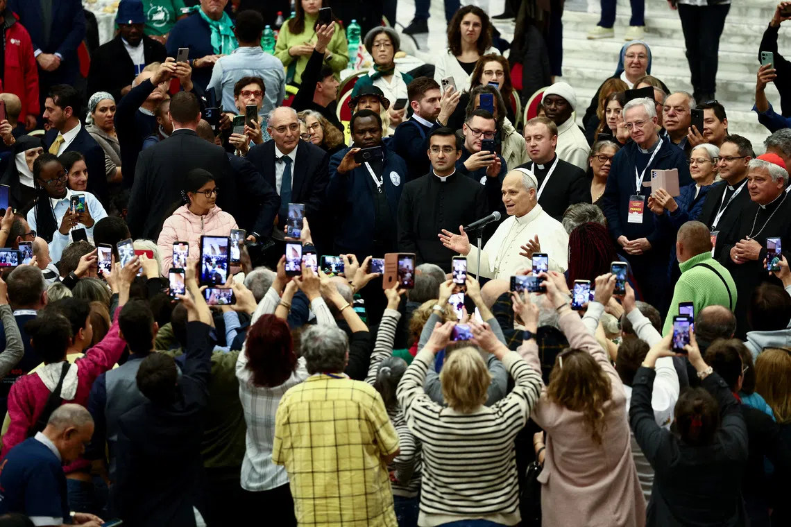 Pope Leo XIV speaks on the day he participates in a lunch with poor people, on World Day of the Poor, in Paul VI Hall at the Vatican, November 16, 2025. REUTERS/Yara Nardi
