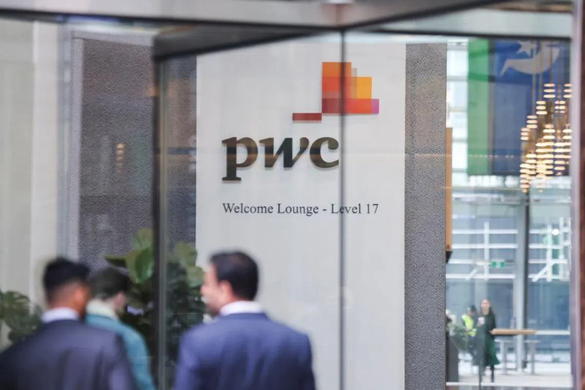 FILE PHOTO: PwC sign is seen in the lobby of their offices in Barangaroo, Australia June 22, 2023. REUTERS/Lewis Jackson/File Photo