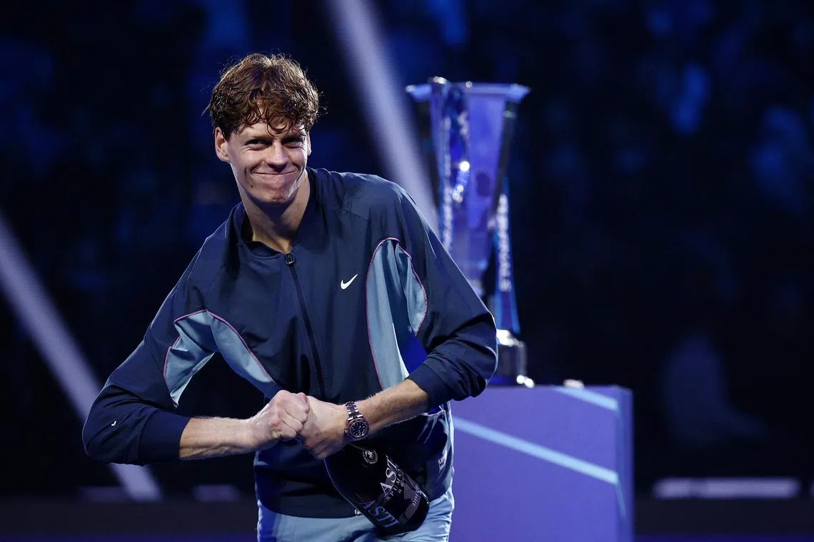 Italy's Jannik Sinner celebrates with champagne after winning the ATP Finals against Taylor Fritz of the US..