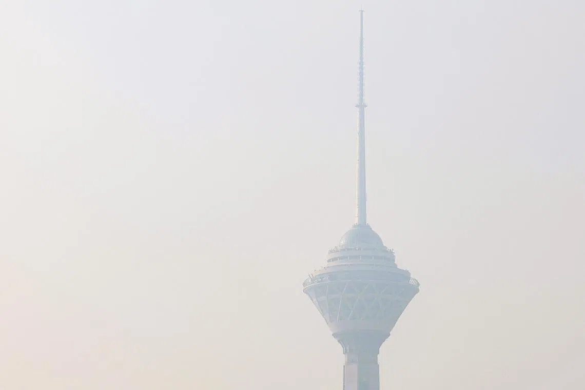 Smog partially obscures Tehran's Milad Tower (Borj-e Milad), the sixth-tallest tower in the world at 435 metres, amid severe air pollution on Dec 11, 2024 as the Iranian capital remains engulfed in smog. 