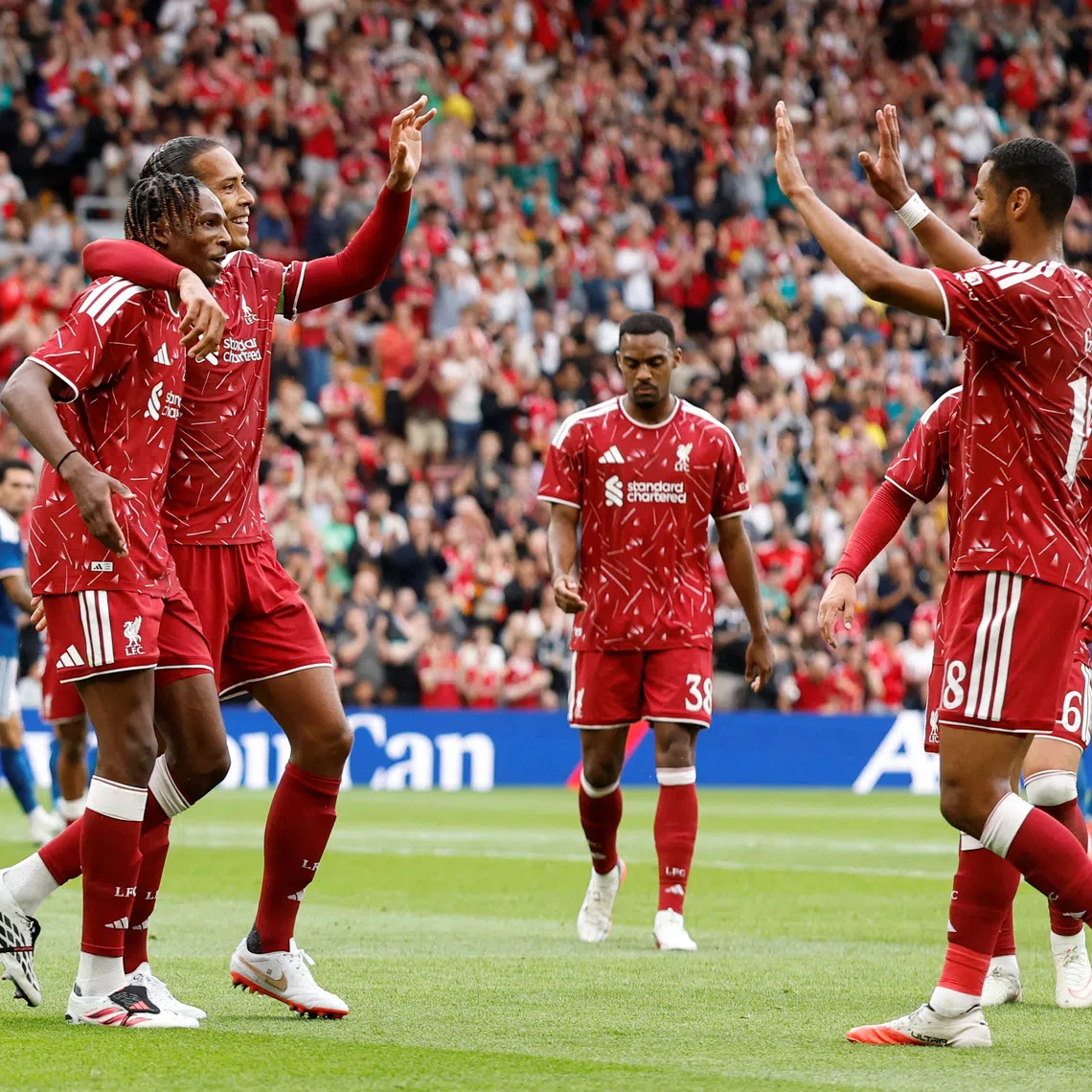 Liverpool’s Jeremy Jacquet celebrates scoring his first goal with teammates Virgil van Dijk and Cody Gakpo.
