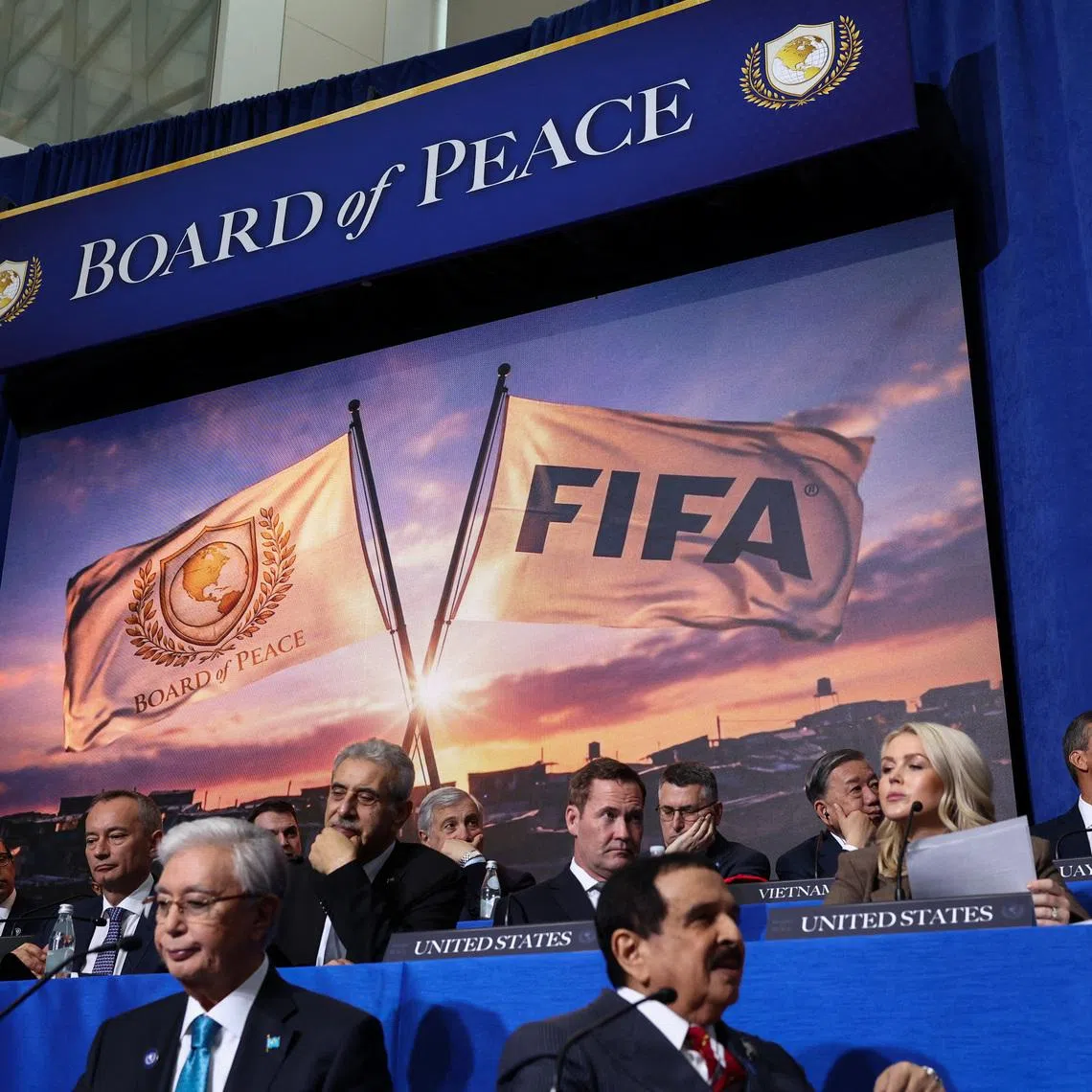 A screen displays an image of FIFA and Board of Peace flags, during the inaugural Board of Peace meeting at the U.S. Institute of Peace in Washington, D.C., U.S., February 19, 2026. REUTERS/Kevin Lamarque