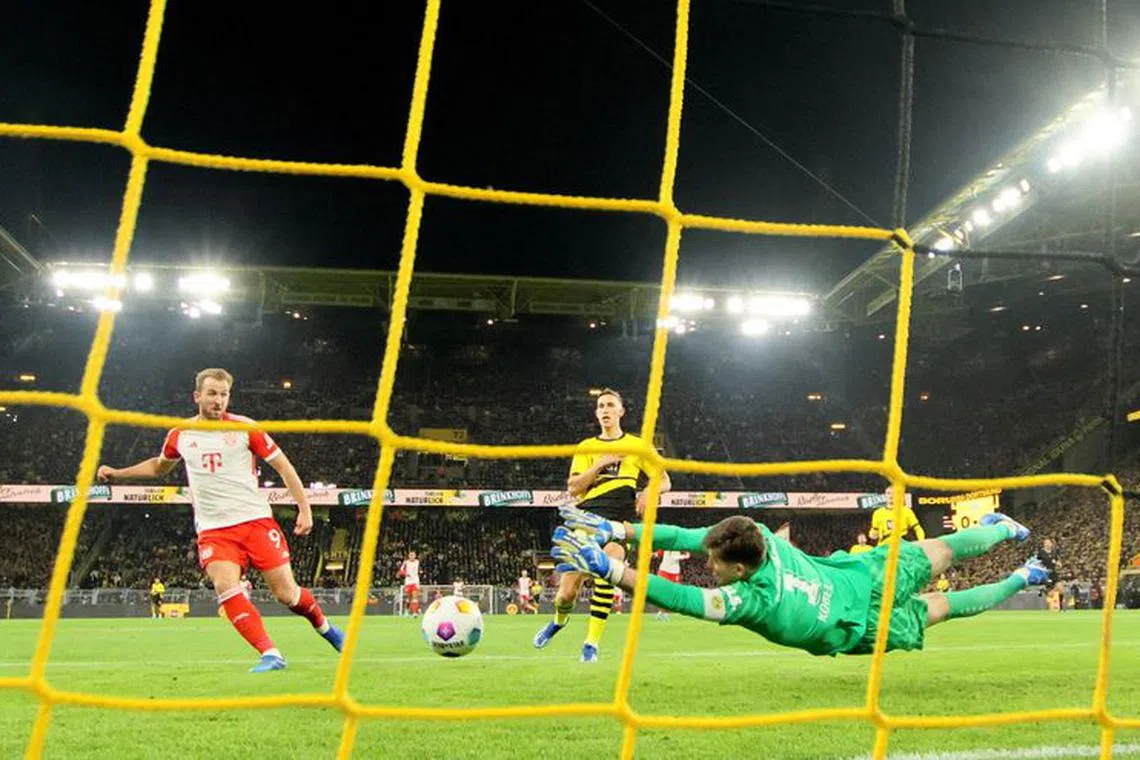 Soccer Football - Bundesliga - Borussia Dortmund v Bayern Munich - Signal Iduna Park, Dortmund, Germany - November 4, 2023 Bayern Munich's Harry Kane scores their second goal past Borussia Dortmund's Gregor Kobel REUTERS/Wolfgang Rattay