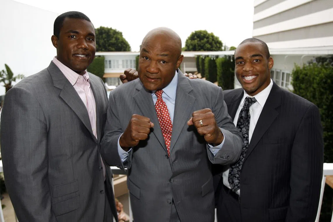 FILE PHOTO: Former heavyweight champion George Foreman (C) and his sons George Foreman III (L) and George Foreman IV pose during the Television Critics Association 2008 summer press tour in Beverly Hills, California July 9, 2008. REUTERS/Mario Anzuoni/File Photo