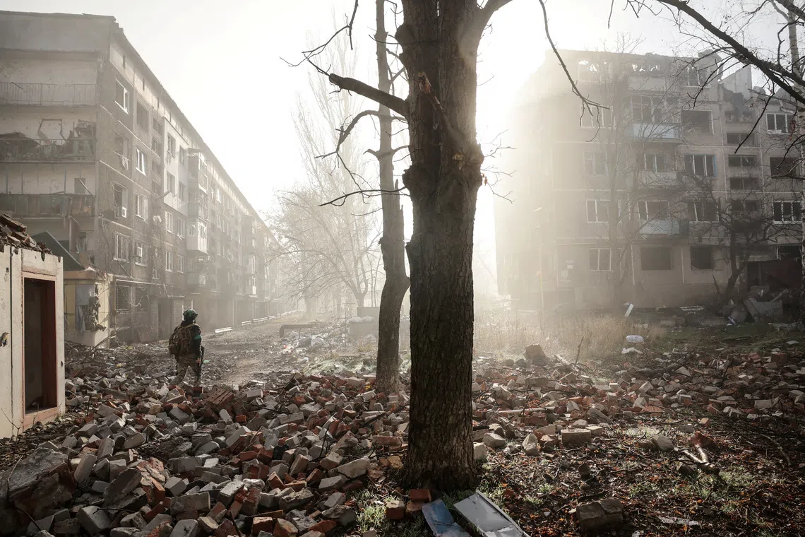 FILE PHOTO: A Ukrainian serviceman walks near apartment buildings damaged by a Russian military strike, in the frontline town of Kostiantynivka in Donetsk region, Ukraine November 15, 2025. Oleg Petrasiuk/Press Service of the 24th King Danylo Separate Mechanized Brigade of the Ukrainian Armed Forces/Handout via REUTERS