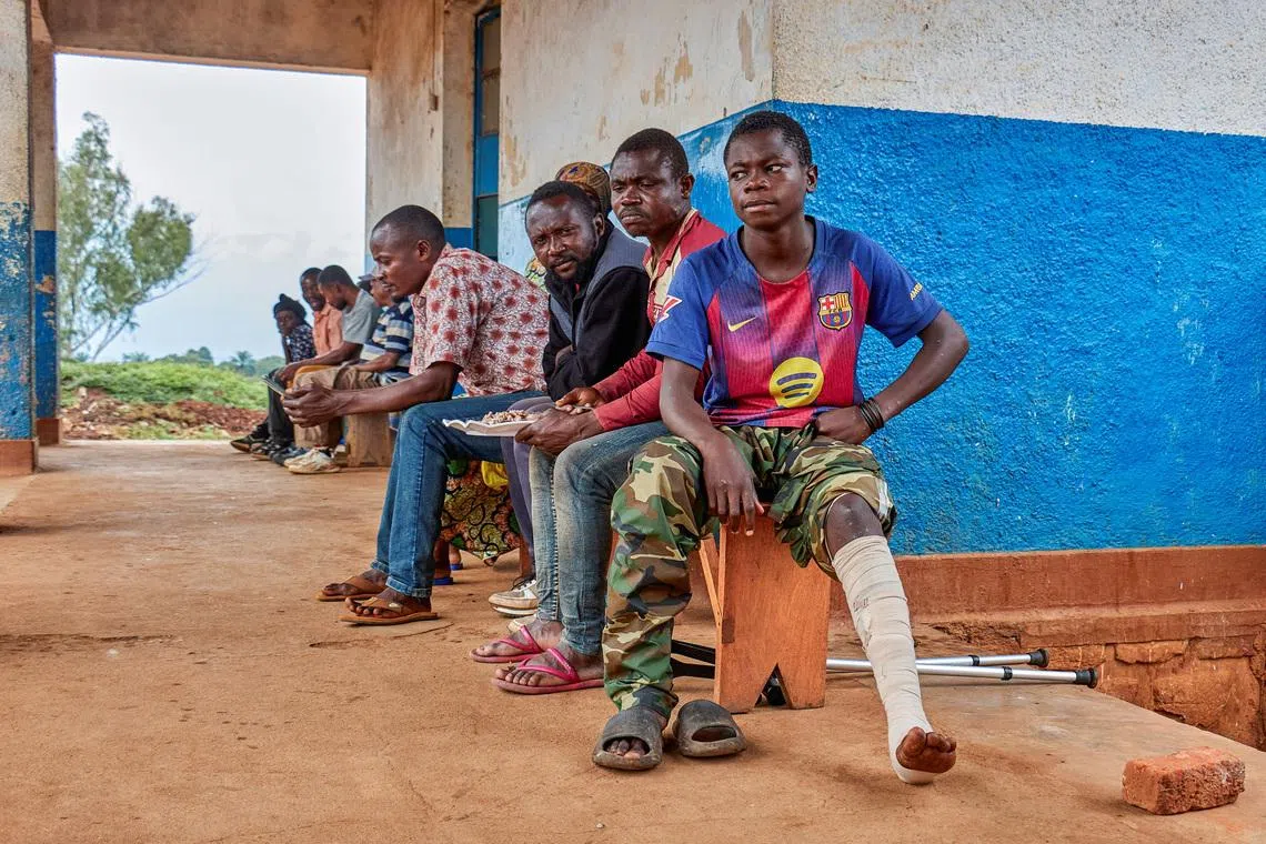 Wilondja Mukula, a member of the Wazalendo militia sits with other patients after the treatment of a bullet wound at the Fizi General Referral Hospital supported by the International Committee of the Red Cross (ICRC), in Fizi territory of South Kivu province, in the eastern Democratic Republic of the Congo January 28, 2026. REUTERS/Gradel Muyisa Mumbere