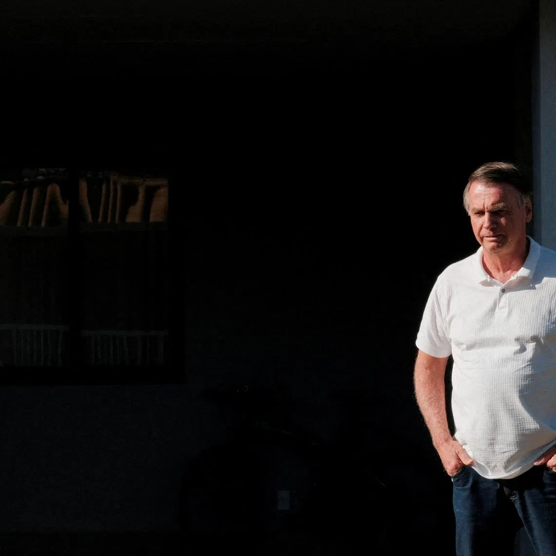 Brazil’s former President Jair Bolsonaro looks on from his home as Sao Paulo’s Governor Tarcisio de Freitas (not pictured) leaves after a visit in Brasilia, Brazil September 29, 2025. REUTERS/Diego Herculano