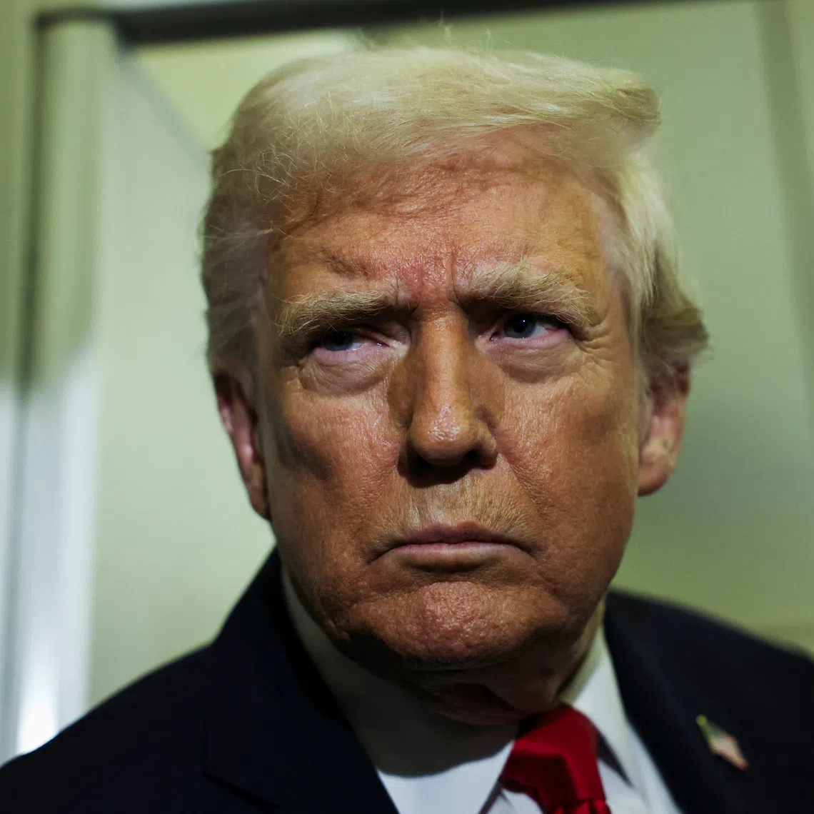 U.S. President Donald Trump looks on aboard Air Force One during travel to Palm Beach, Florida, from Joint Base Andrews, Maryland, U.S., November 25, 2025. REUTERS/Anna Rose Layden