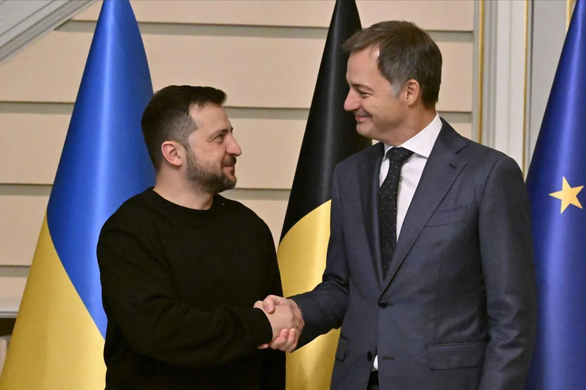 Ukraine's President Volodymyr Zelensky (left) is welcomed by Belgian Prime Minister Alexander De Croo in Brussels.