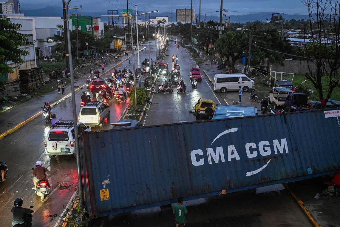 A shipping container blocks a road after it was swept away by the floods brought by Typhoon Kalmaegi in Mandaue City, Cebu, Philippines, on Nov 5, 2025. 
