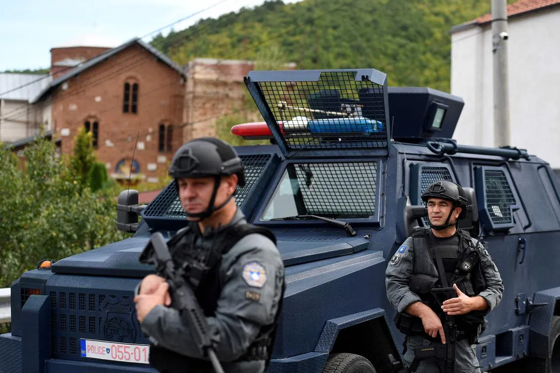 Members of a Kosovo police special unit stand guard in an area around the Banjska Monastery, in north Kosovo.