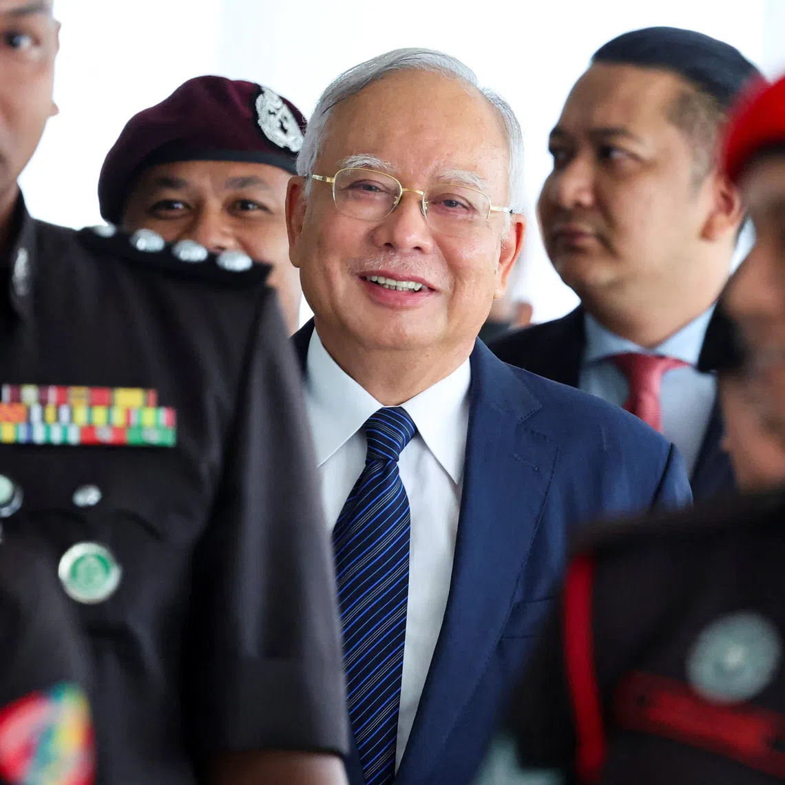 Prison officers escort former Malaysian Prime Minister Najib Razak, as the jailed politician leaves the court during a break in proceedings, in Kuala Lumpur, Malaysia, April 4, 2024. REUTERS/Hasnoor Hussain