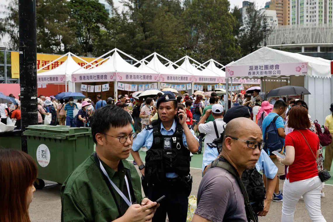 A policeman stands guard at a food carnival held by pro-China groups, taking place where the Tiananmen candlelight vigil used to be held, in Hong Kong, on June 2.