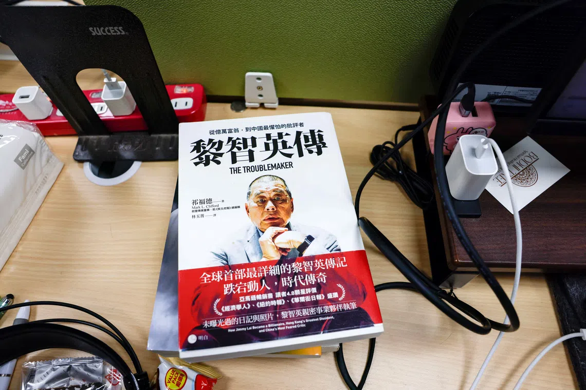 A book about media tycoon Jimmy Lai, founder of Apple Daily, lies on a table where former Apple Daily reporters work in Taipei, Taiwan, December 15, 2025. REUTERS/Ann Wang