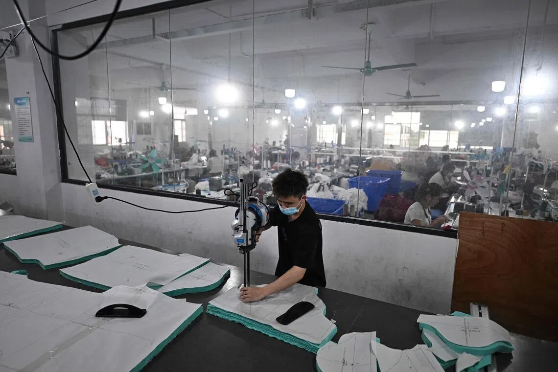 Employees work in a clothing sewing workshop in an urban village in Guangzhou, in southern China’s Guangdong province, on April 27.