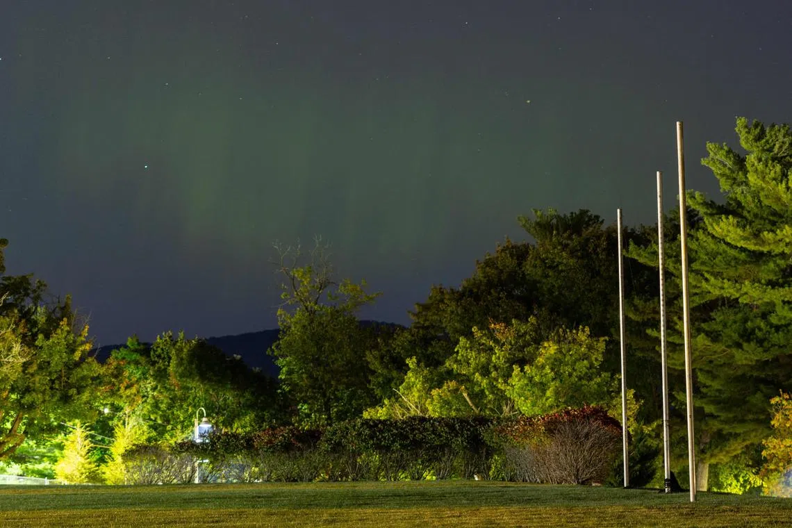 Aurora borealis, or northern lights, produced by a solar geomagnetic storm lights the sky in Nyack, New York, on Oct 11.