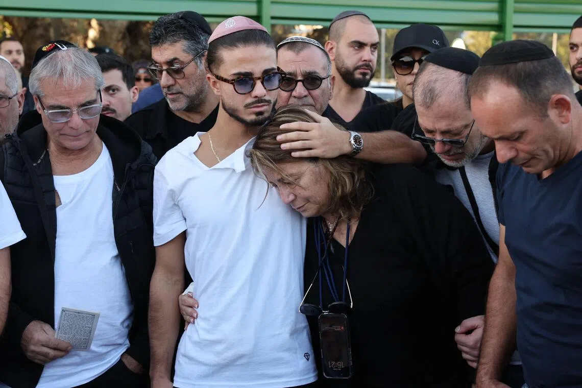 Relatives and friends of Mr Dan Elkayam, who was killed in the terrorist attack at Bondi Beach in Australia, mourn during his funeral at the Ashdod cemetery in southern Israel. 