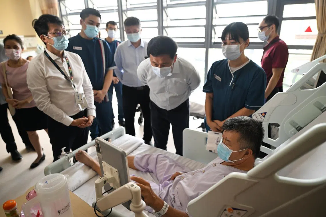 Health Minister Ong Ye Kung interacting with a patient at the new Tan Tock Seng Hospital Integrated Care Hub.