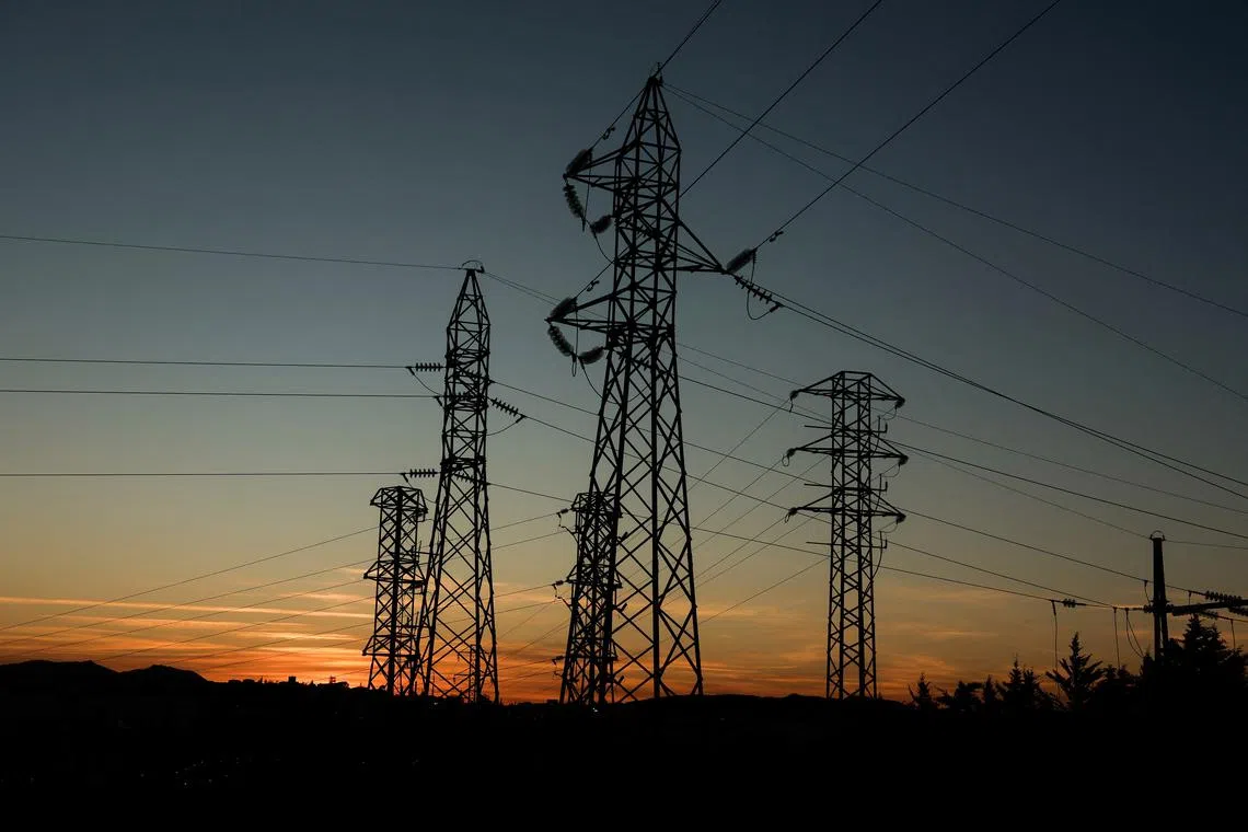 FILE PHOTO: Power lines connecting pylons of high-tension electricity are seen during sunset at an electricity substation on the outskirts of Ronda, during a blackout in the city, Spain April 28, 2025. REUTERS/Jon Nazca/ File Photo