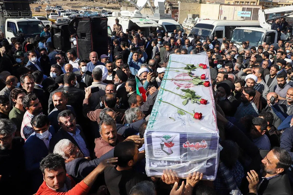 Iranians carry the coffin of one of the people killed in a shooting attack in Khuzestan province in Iran on Nov 18, 2022.