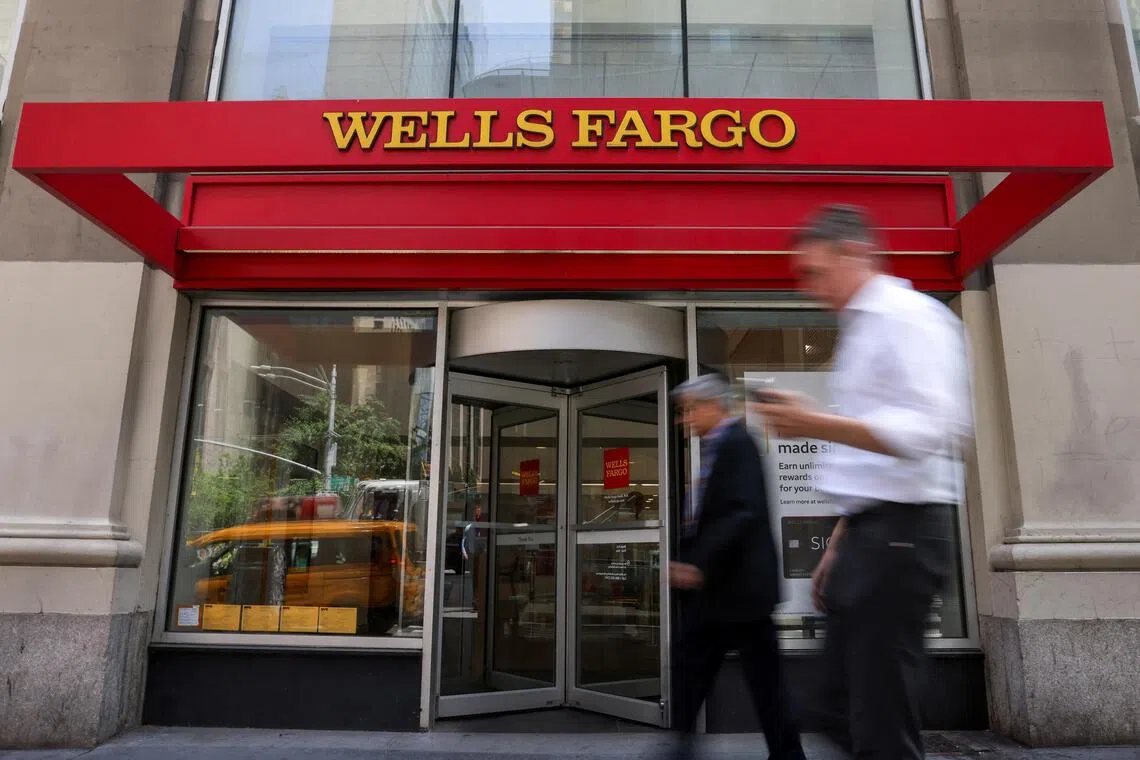 FILE PHOTO: People walk by a Wells Fargo bank branch in New York City, U.S., June 4, 2025. REUTERS/Kylie Cooper/File Photo