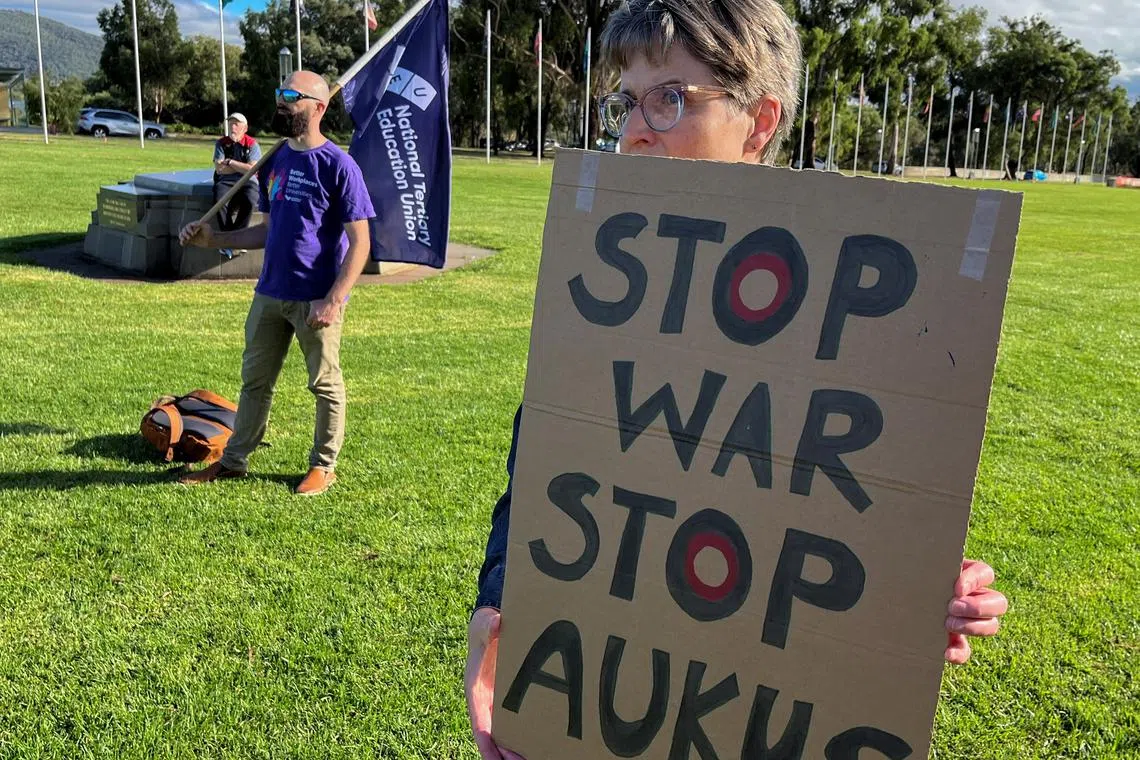 Anti-AUKUS protesters stand outside Australia’s parliament, in Canberra, Australia, March 18, 2024. REUTERS/Lewis Jackson