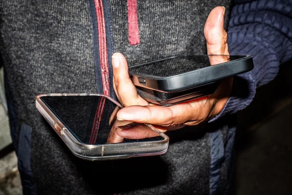 Choudhary Muhammad Kamran, an entrepreneur with businesses in Dubai, New York, Singapore and Pakistan, with two phones and a battery bank in New York.