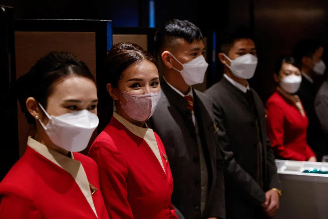 Cathay Pacific flight attendants stand during the first recruitment day since the COVID-19 pandemic, in Hong Kong, China October 7, 2022. REUTERS/Tyrone Siu