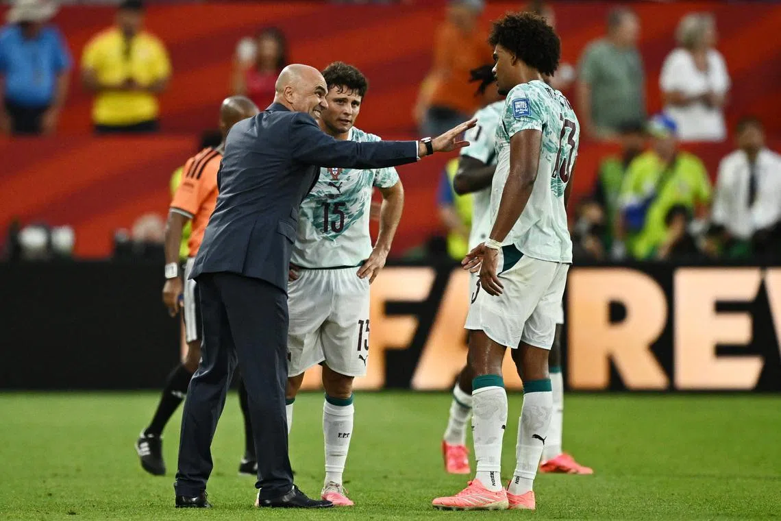Soccer Football - FIFA World Cup 2026 - Round of 32 - Portugal v Croatia - Toronto Stadium, Toronto, Canada - July 2, 2026 Portugal coach Roberto Martinez reacts with Joao Neves and Renato Veiga REUTERS/Dylan Martinez